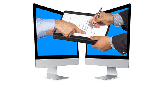 Hands extending from two monitors to sign a contract