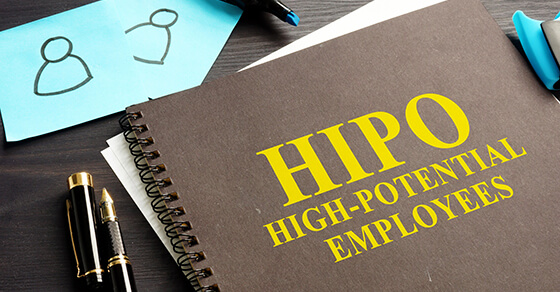 Notebook on a desk with the title HIPO High-Potential Employee