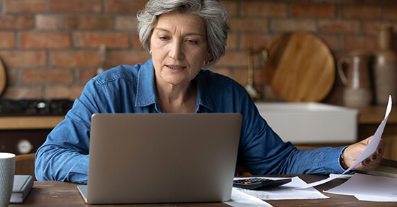 Woman sitting at a desk working on her laptop