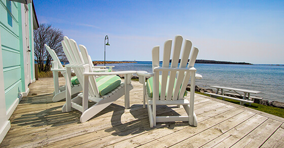 Beach chairs on a deck near the ocean