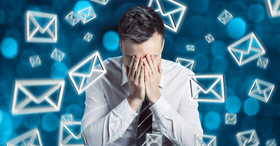 Man holding his face surrounded by symbols representing email