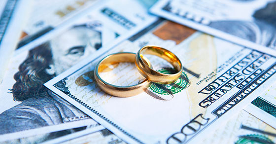 wedding rings on top of a pile of cash