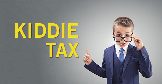 Child in a blue suit wearing glasses poitig at the words Kiddie Tax